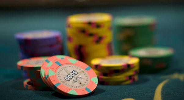 Stacks of poker and craps chips on a gaming table.