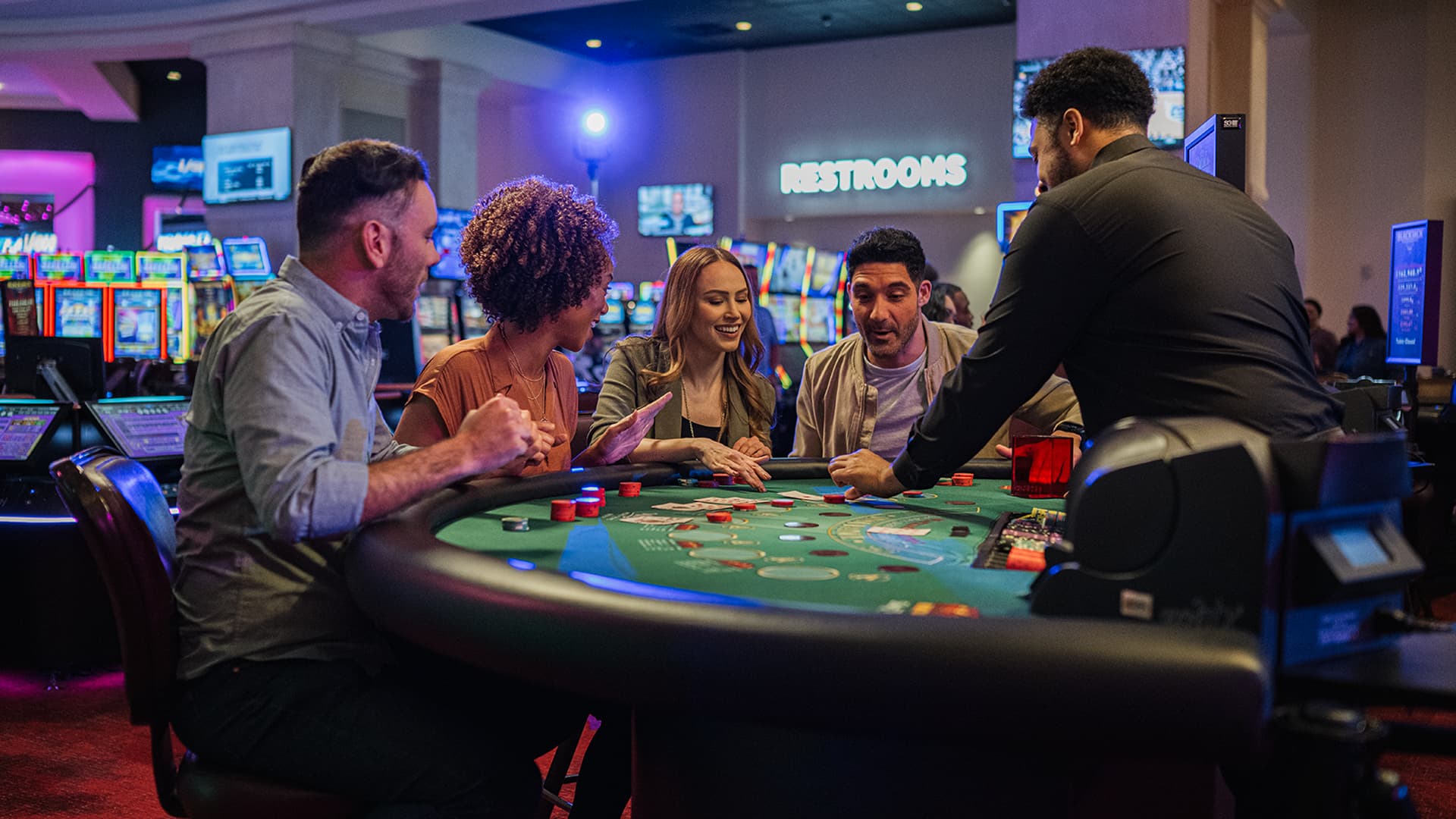 A blackjack dealer at WinStar World Casino managing cards and chips on a green table.