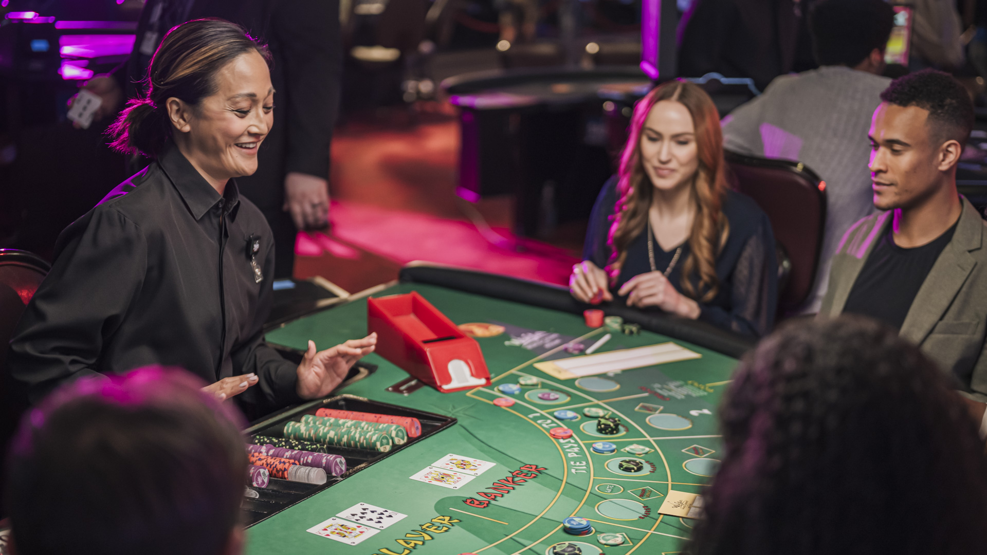 Players at a Mini Baccarat table.