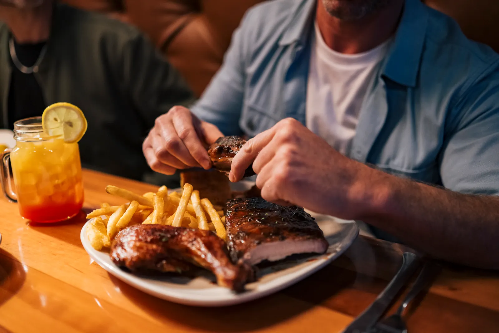 A man eating ribs at Toby Keith's.