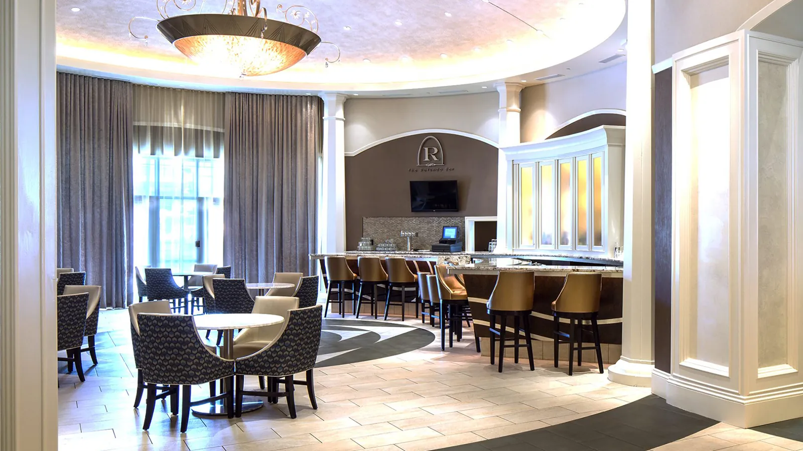 The interior of The Rotunda Bar. There are tables gathered around the venue.