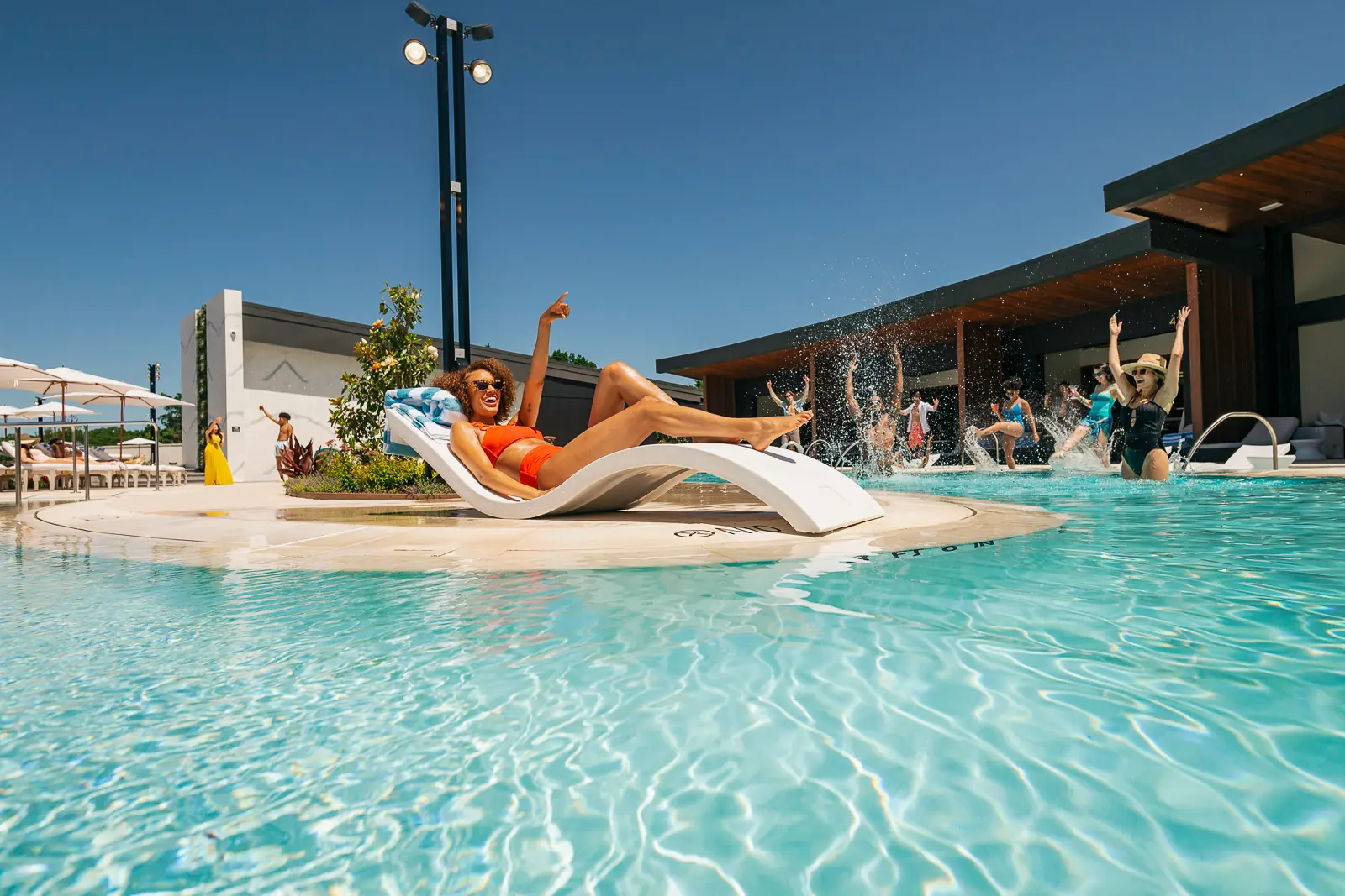 A woman lounging poolside at Cascades.