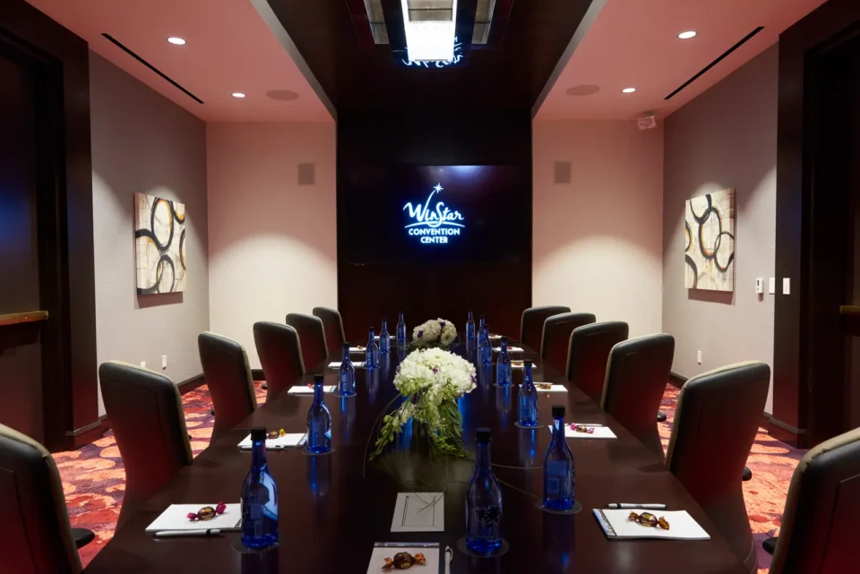 A table with bottled water at each chair in the WinStar World Casino & Resort Meeting Center.