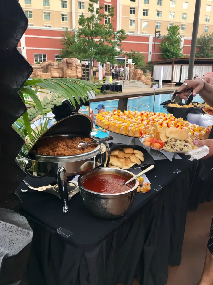 A table full of catered food at the WinStar World Casino & Resort pool.