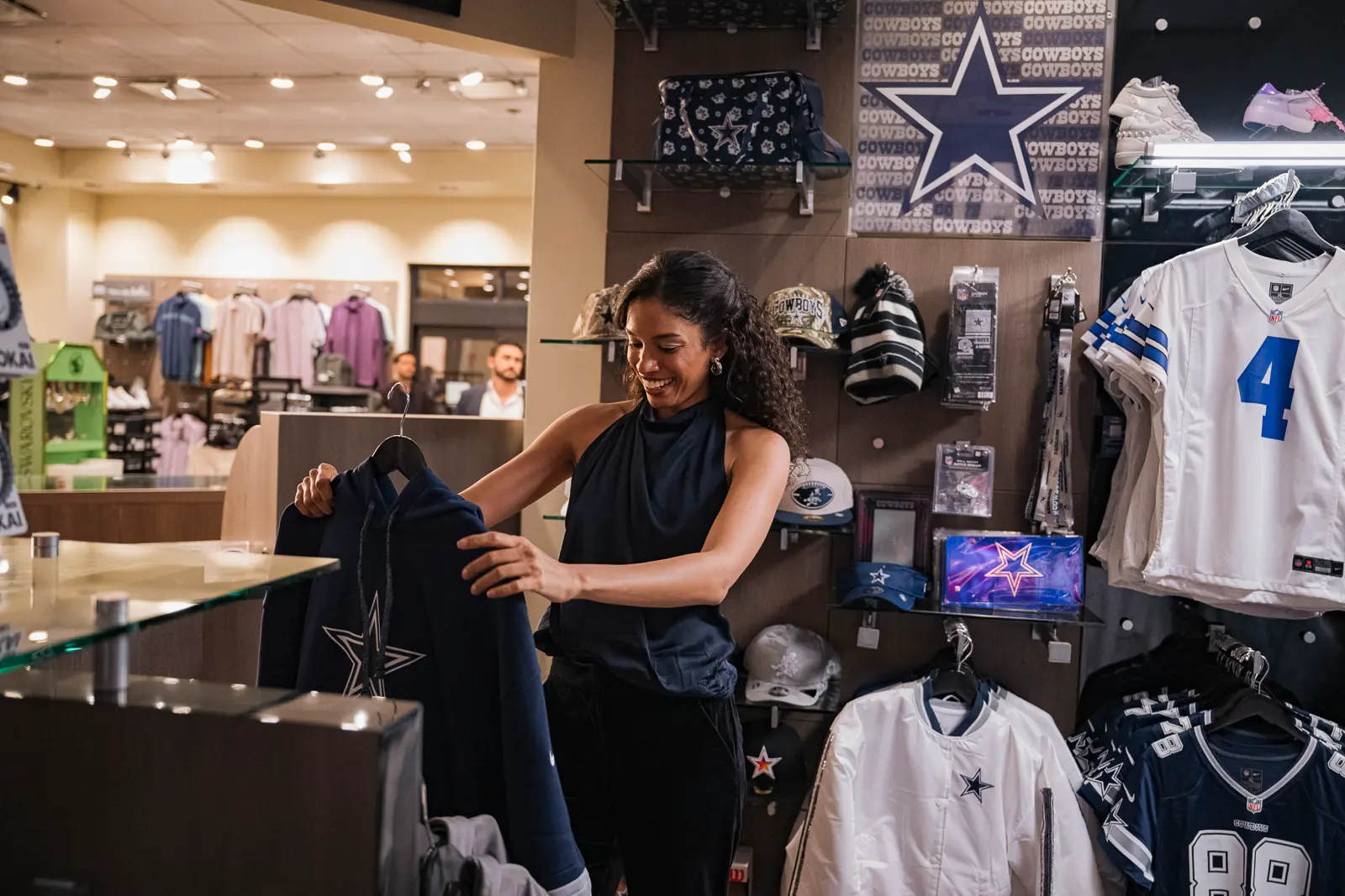 A woman shopping for Dallas Cowboys apparel.