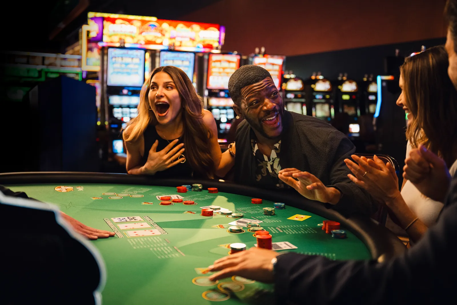 A group of people enjoying a game of Mississippi Stud at WinStar World Casino and Resort.