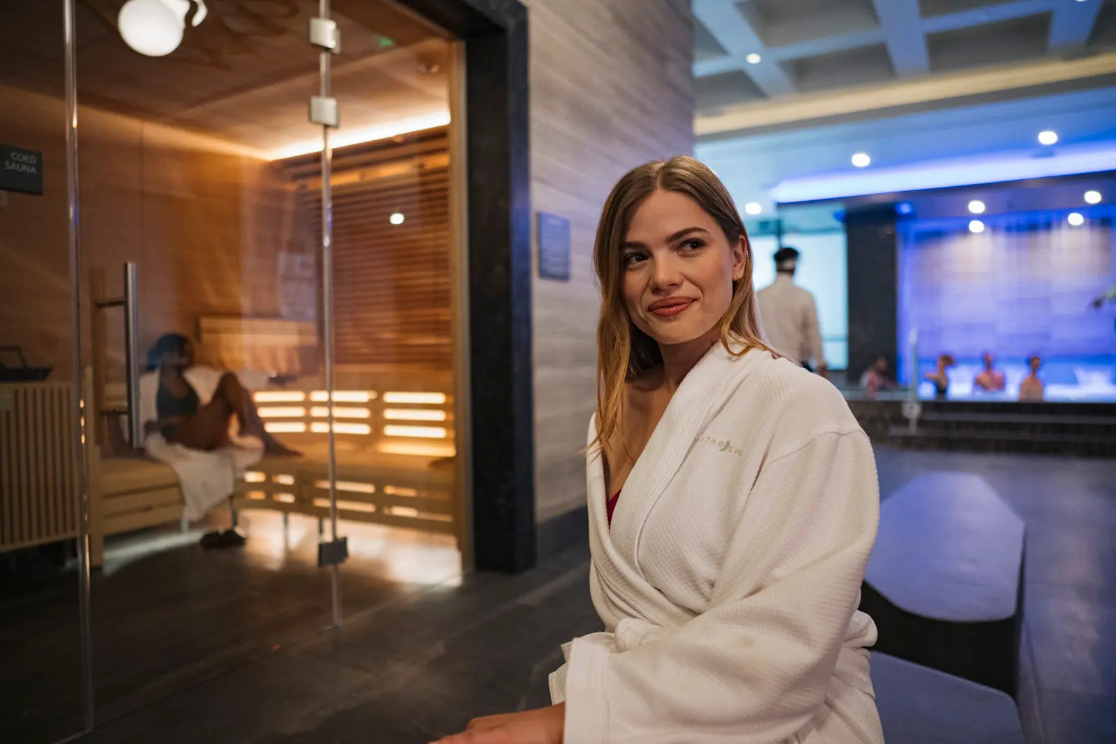 A woman sitting outside the sauna at WinStar Spa.