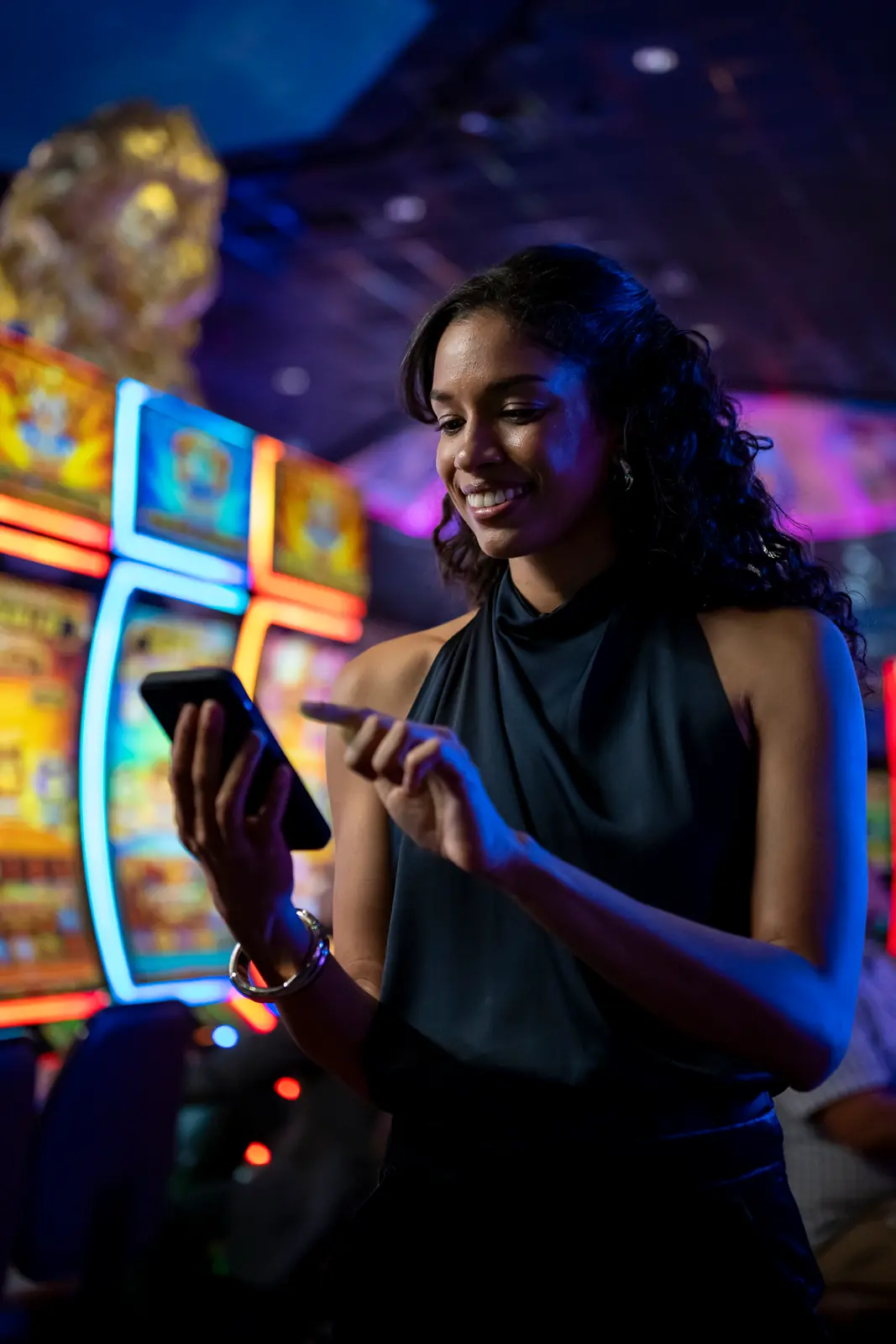 A woman on her phone looking at her My WinStar account.