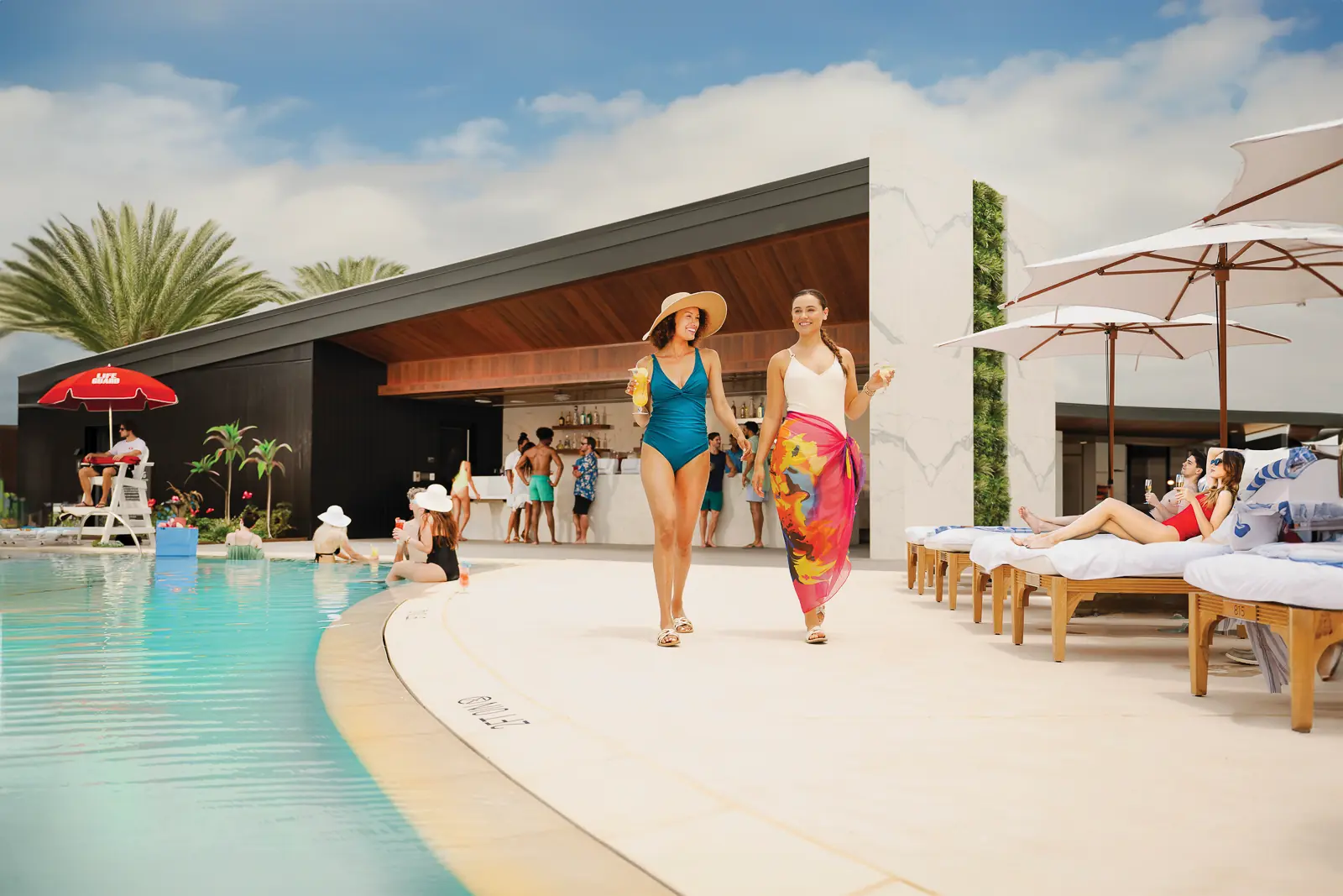 Two women walking pool side at WinStar World Casino and Resort.